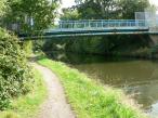 Pipes and footbridge 79a crossing The Grand Union Canal, England.